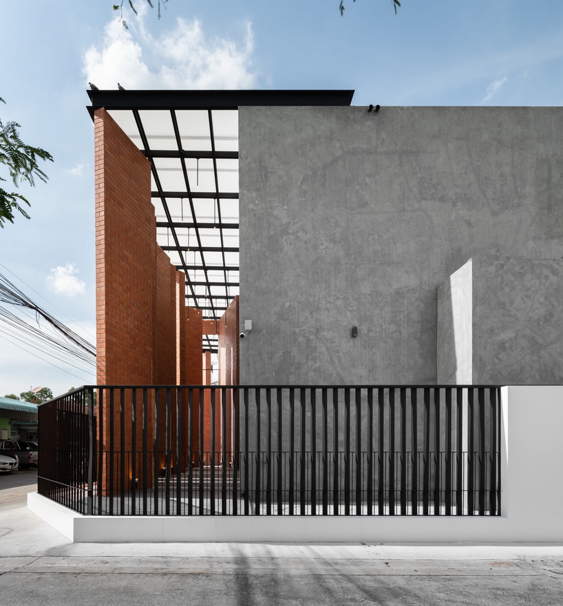 a wall of terracotta tiles shield archimontage's pakkret house in thailand designboom