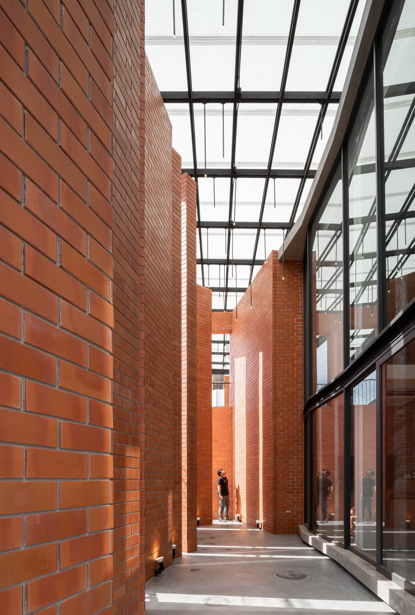a wall of terracotta tiles shield archimontage's pakkret house in thailand designboom