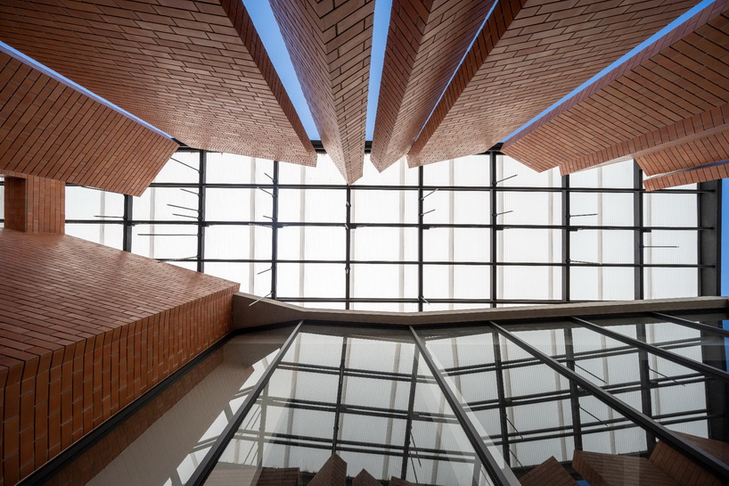 a wall of terracotta tiles shield archimontage's pakkret house in thailand designboom