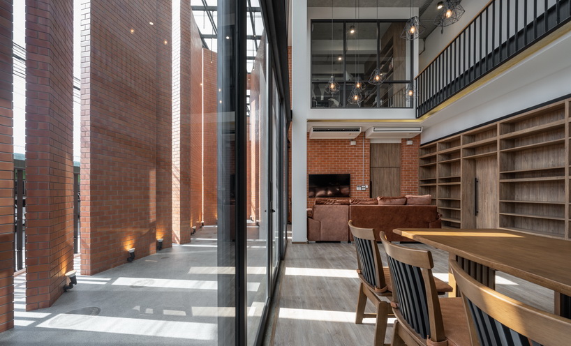 a wall of terracotta tiles shield archimontage's pakkret house in thailand designboom