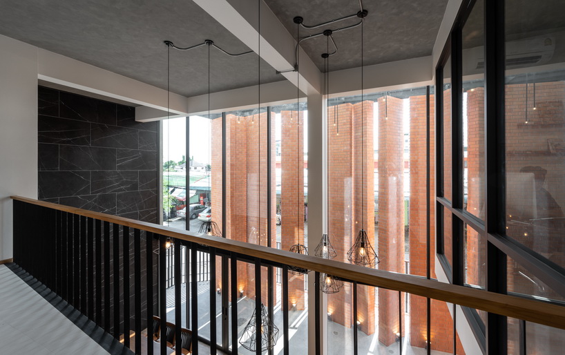 a wall of terracotta tiles shield archimontage's pakkret house in thailand designboom