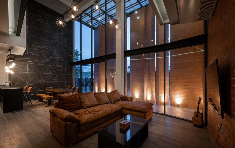 a wall of terracotta tiles shield archimontage's pakkret house in thailand designboom