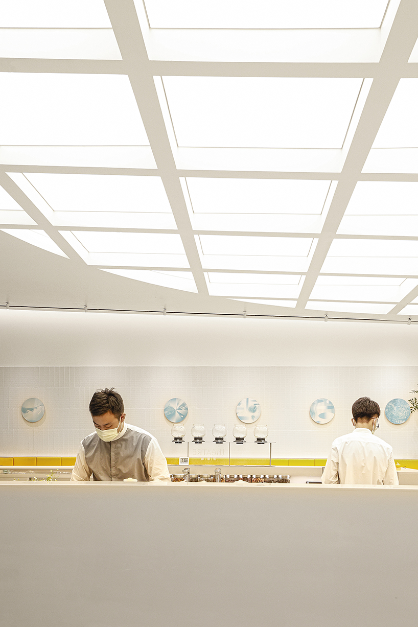 curved yellow walls define theatrical pastry shop interior by ramoprimo in beijing