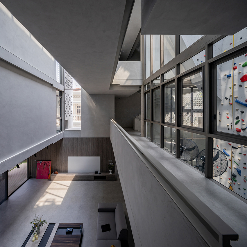 anonym studio creates house with brick façade and climbing wall in thailand