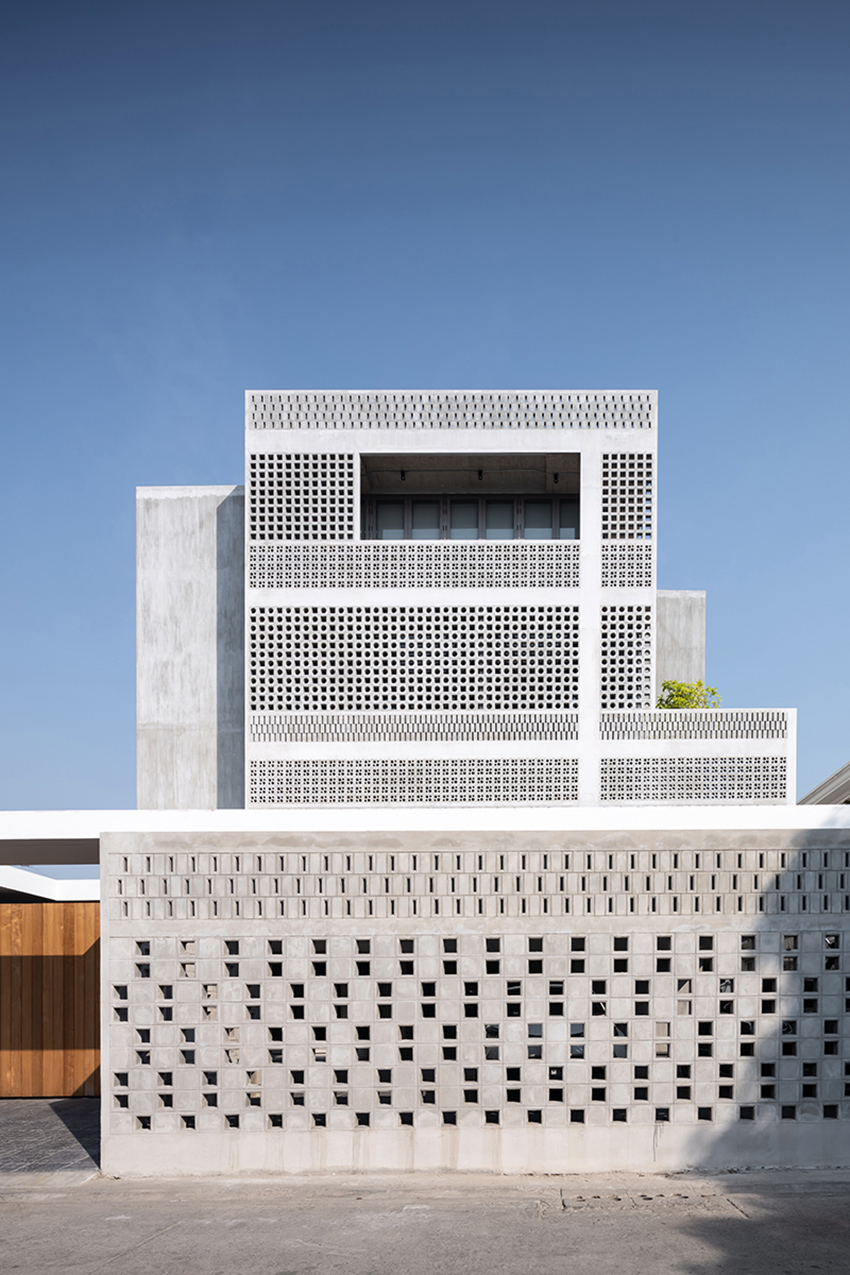 anonym studio creates house with brick façade and climbing wall in thailand