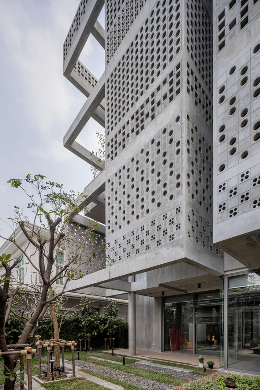 anonym studio creates house with brick façade and climbing wall in thailand