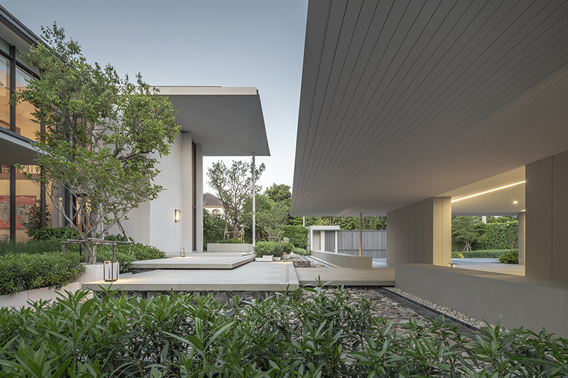 volumes, voids, and a warm ambience shape anonym studio's feng shui home in bangkok