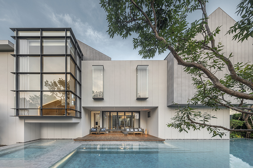 volumes, voids, and a warm ambience shape anonym studio's feng shui home in bangkok
