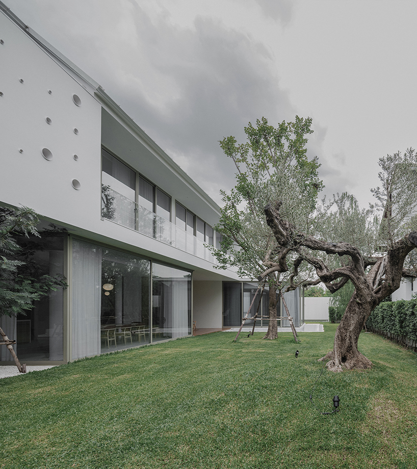 anonym studio's all-white house in bangkok adopts scandinavian minimalism