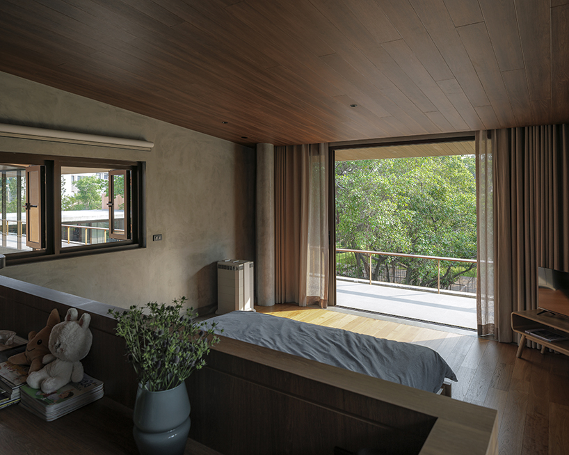a pair of banyan trees anchors anonym studio’s open-air family house in thailand - 11