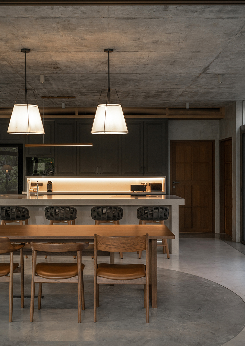 a pair of banyan trees anchors anonym studio’s open-air family house in thailand - 6
