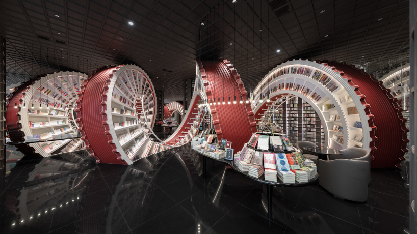 huge spiral staircase serving as a bookshelf takes over x+living's store in china