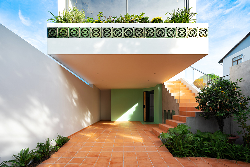 serpentine pink staircase highlights the inclination of AD+studio's house in vietnam