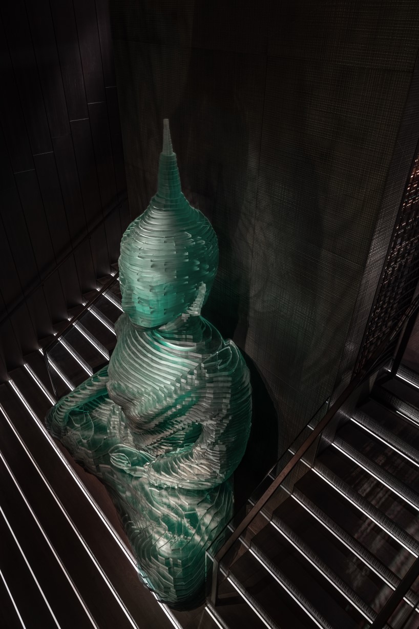 4.5-meter-tall glass-hewn buddha sculpture decorates restaurant interior by YOD group in new york