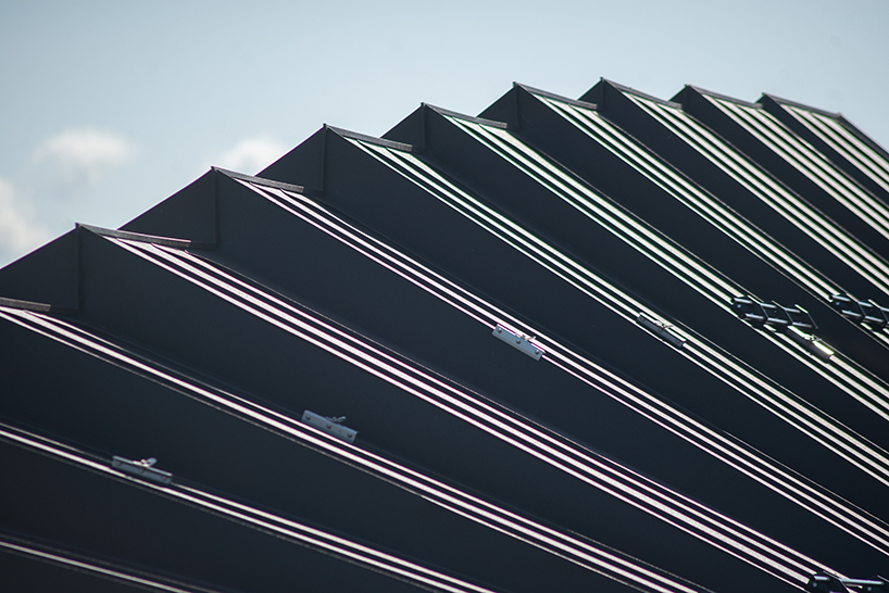 undulating tiered rafter by studio beltrame envelops ski school in italy