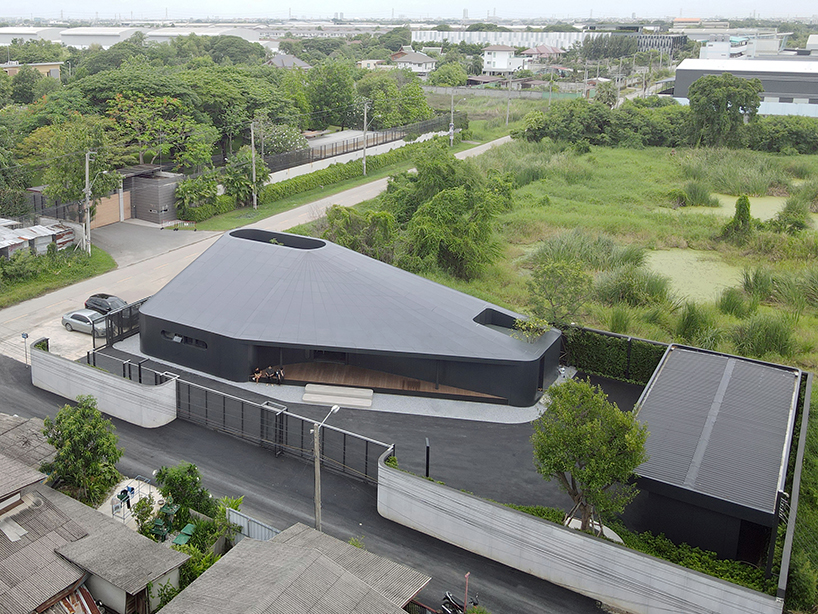 ASWA wraps office into metallic black aluminum mimicking the brand's packaging products