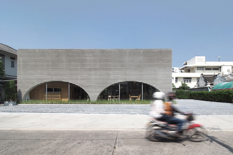 a new restaurant with a wavy precast facade that resembles a wave by aswa 1