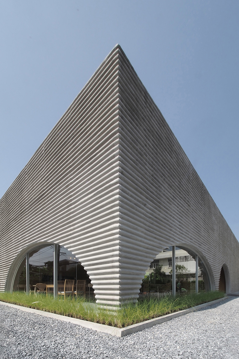 a new restaurant with a wavy precast facade that resembles a wave by aswa 3