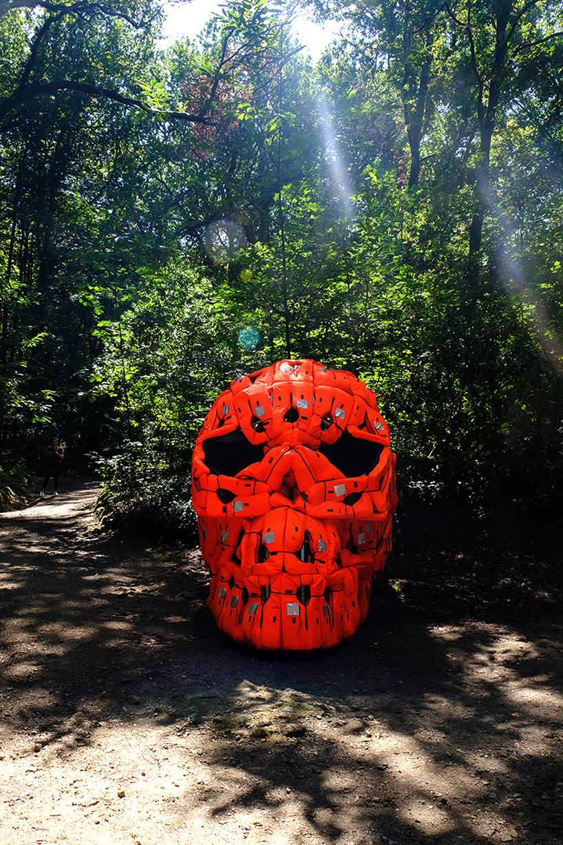 pedro pires sculpts large-scale skull using 140 life vests and rubber from a refugee dinghy designboom