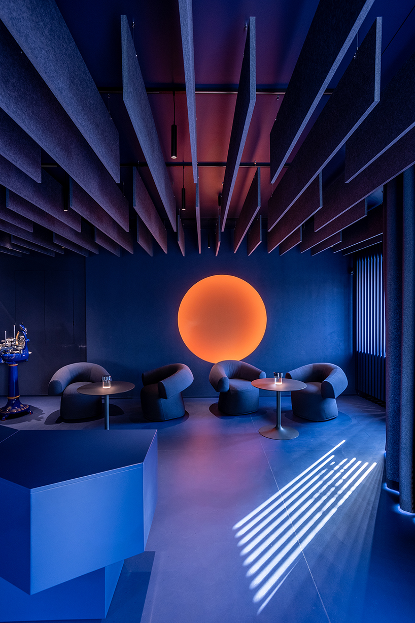 visual display immerses italian restaurant and bar lounge in neon orange light