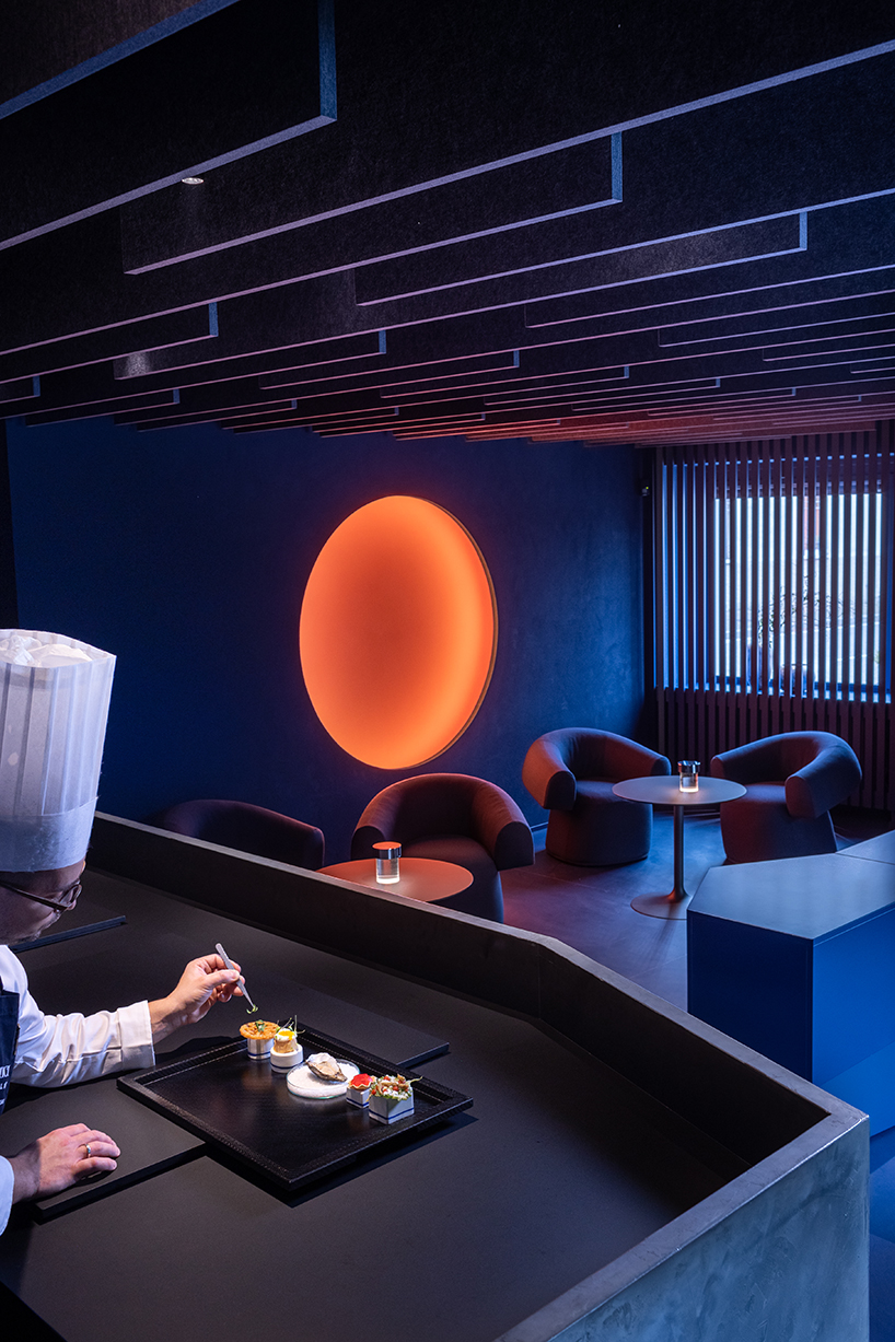 visual display immerses italian restaurant and bar lounge in neon orange light