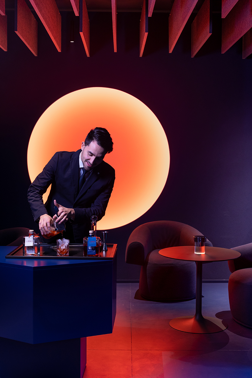 visual display immerses italian restaurant and bar lounge in neon orange light