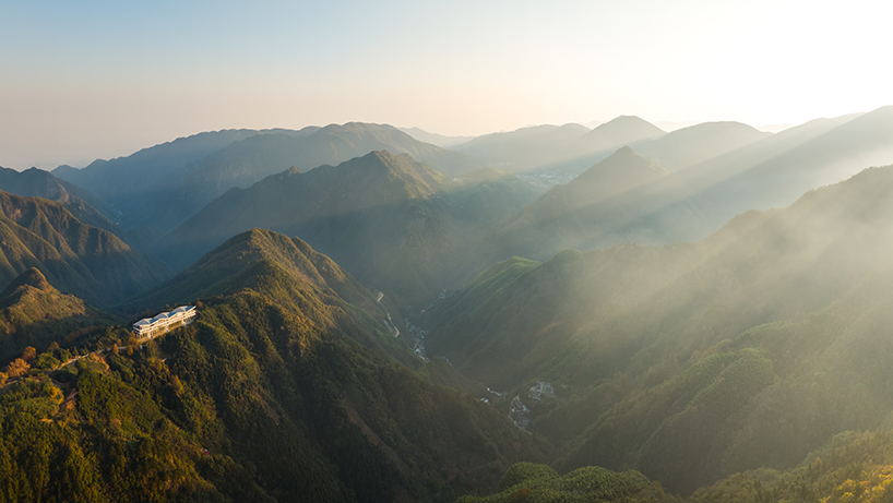 folded zinc roof undulates atop floating hotel by more architecture in china