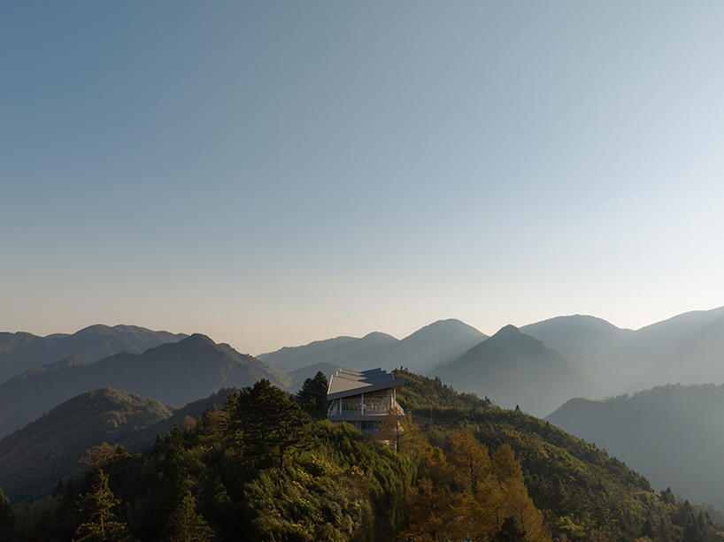 folded zinc roof undulates atop floating hotel by more architecture in china