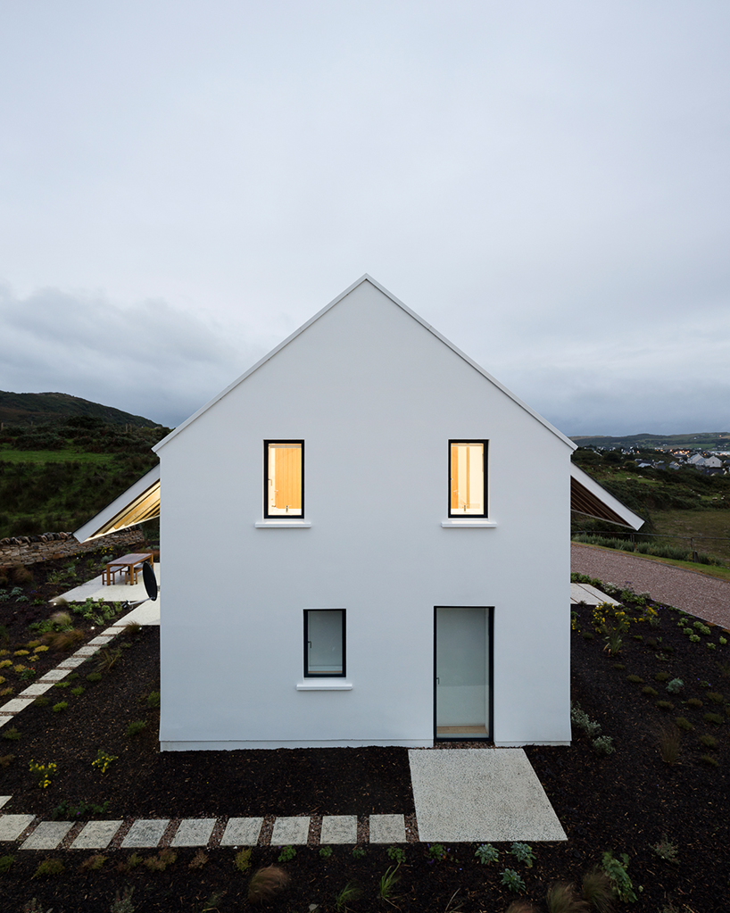 DUA completes cladach house with simple interiors and deep pitched roof in ireland