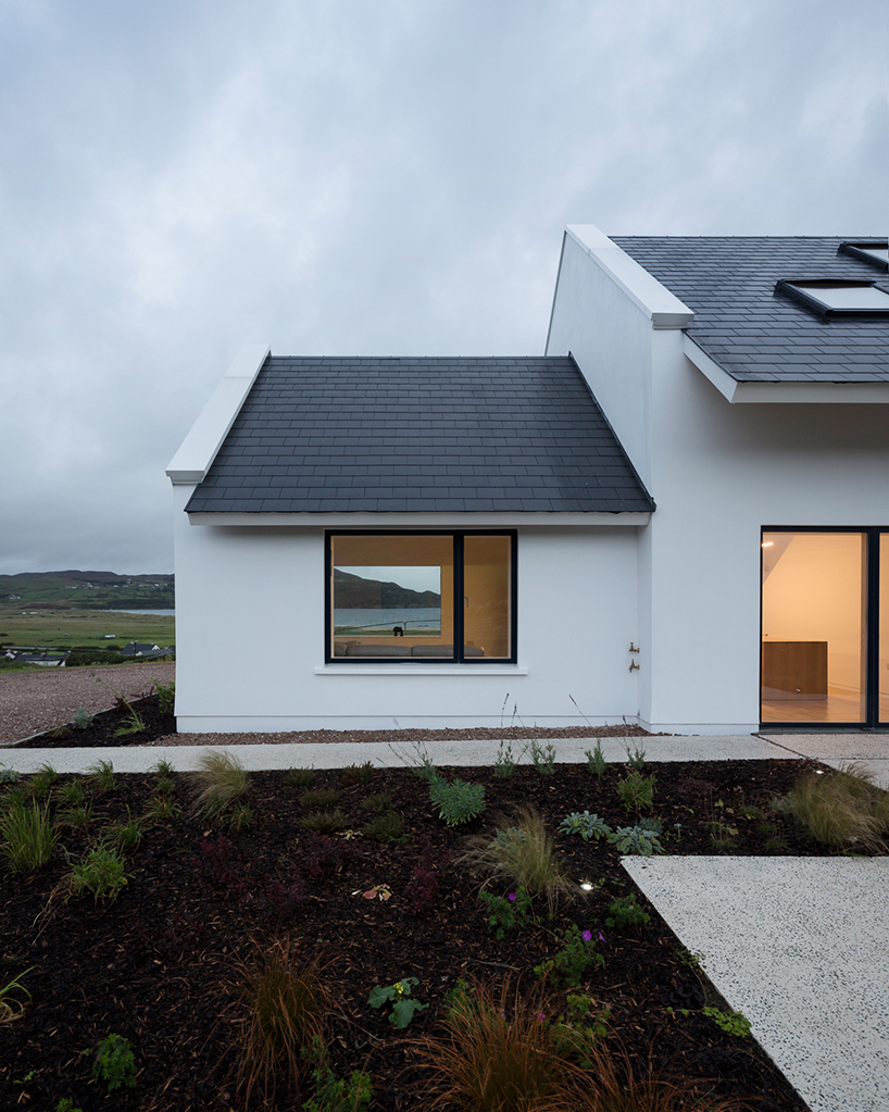 DUA completes cladach house with simple interiors and deep pitched roof in ireland