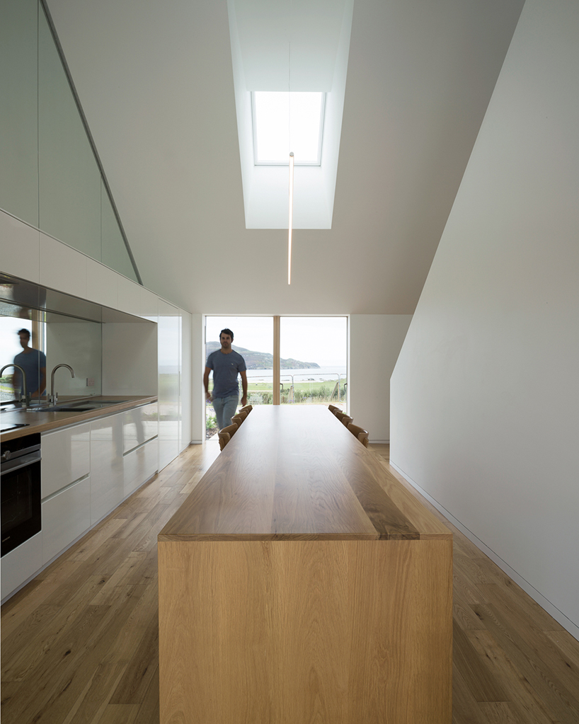 DUA completes cladach house with simple interiors and deep pitched roof in ireland