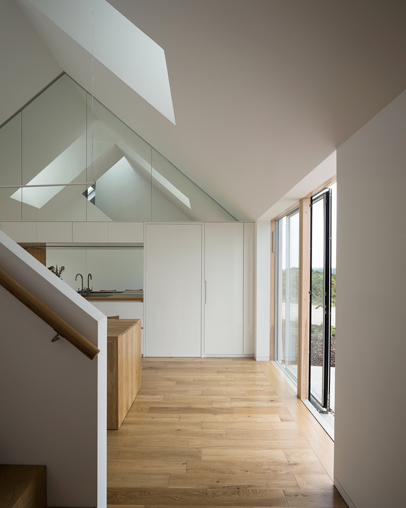 DUA completes cladach house with simple interiors and deep pitched roof in ireland