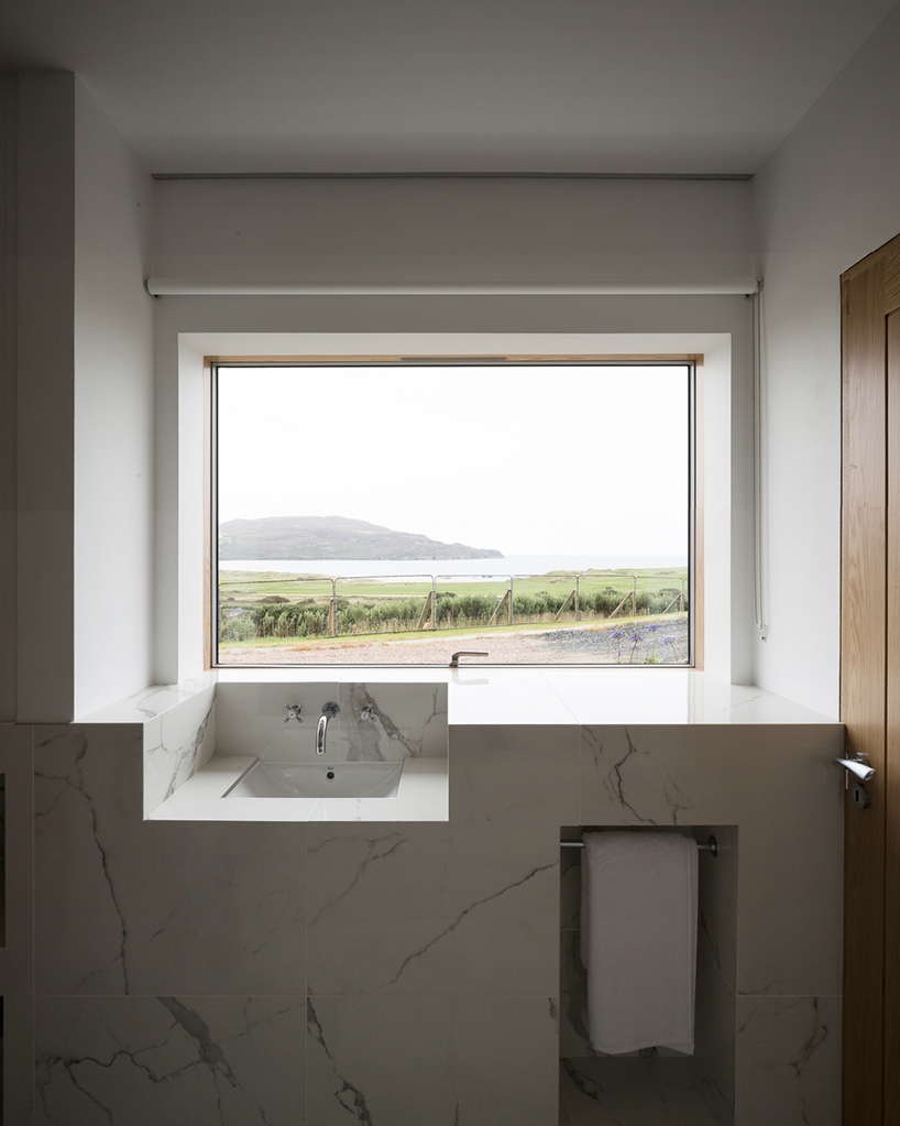 DUA completes cladach house with simple interiors and deep pitched roof in ireland