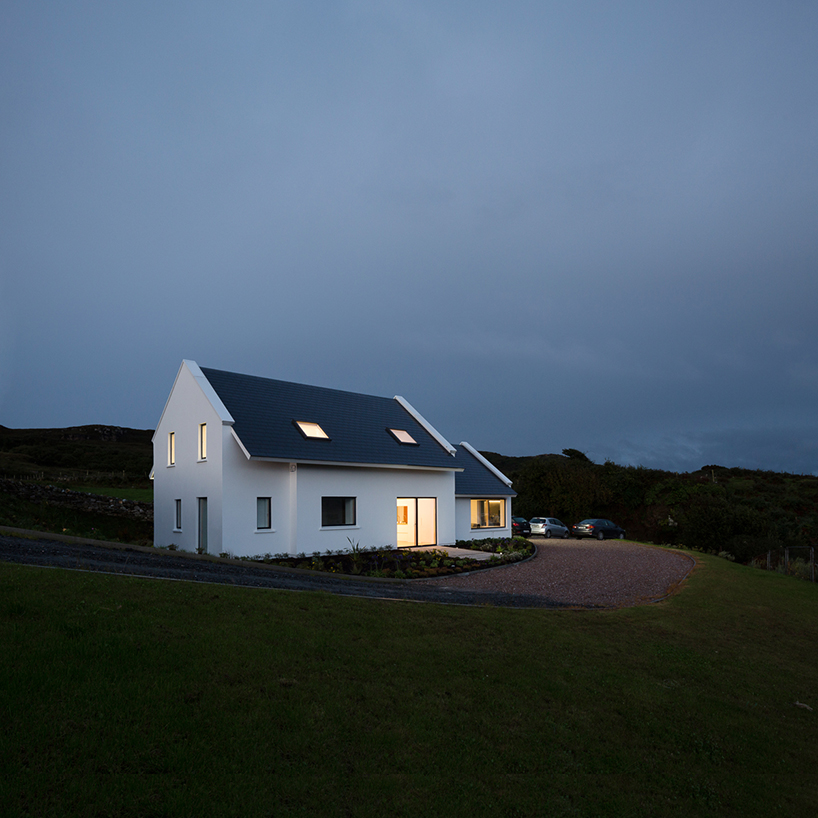 DUA completes cladach house with simple interiors and deep pitched roof in ireland