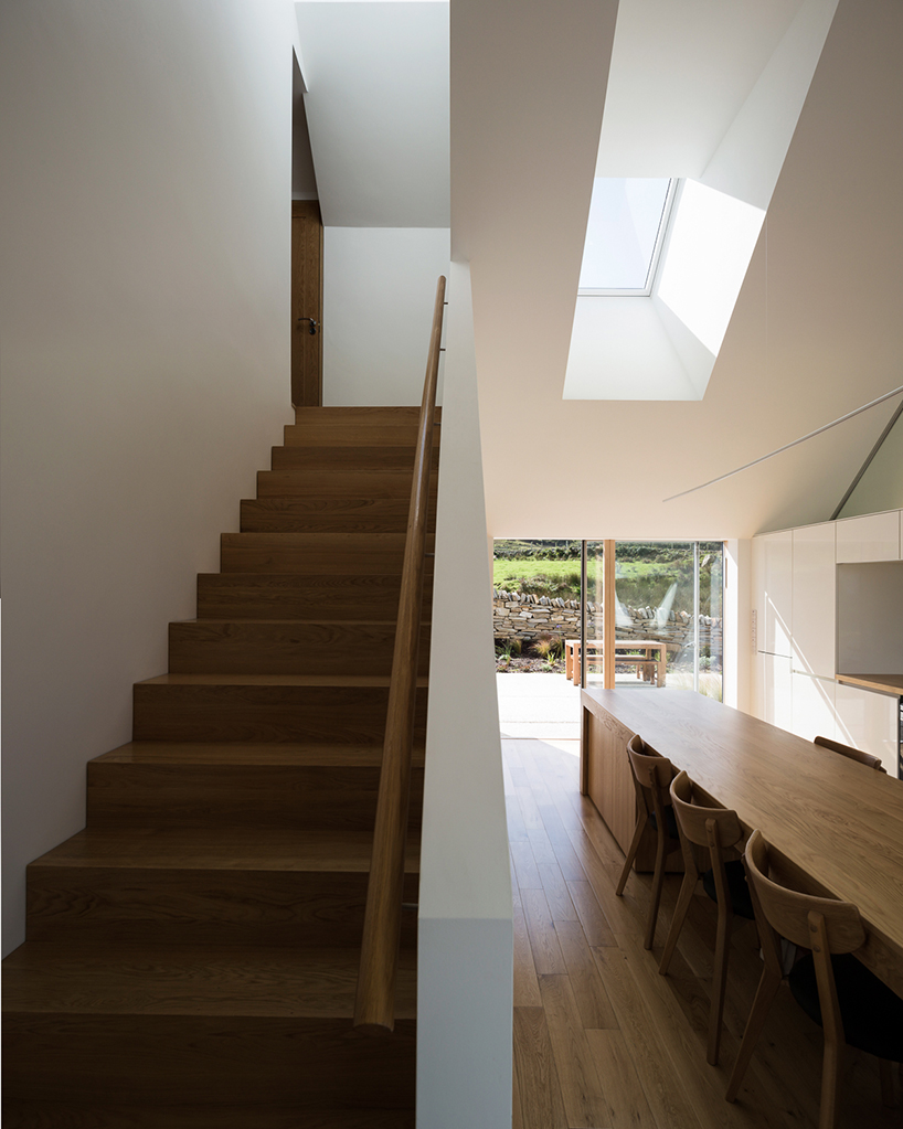 DUA completes cladach house with simple interiors and deep pitched roof in ireland