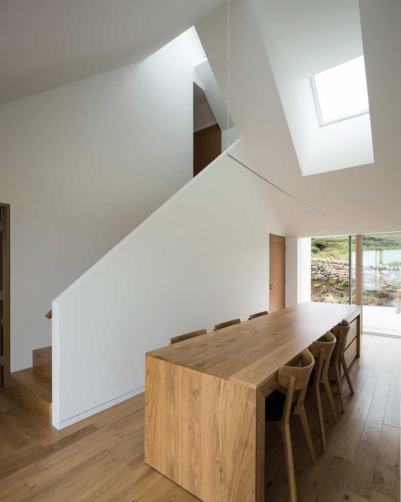 DUA completes cladach house with simple interiors and deep pitched roof in ireland
