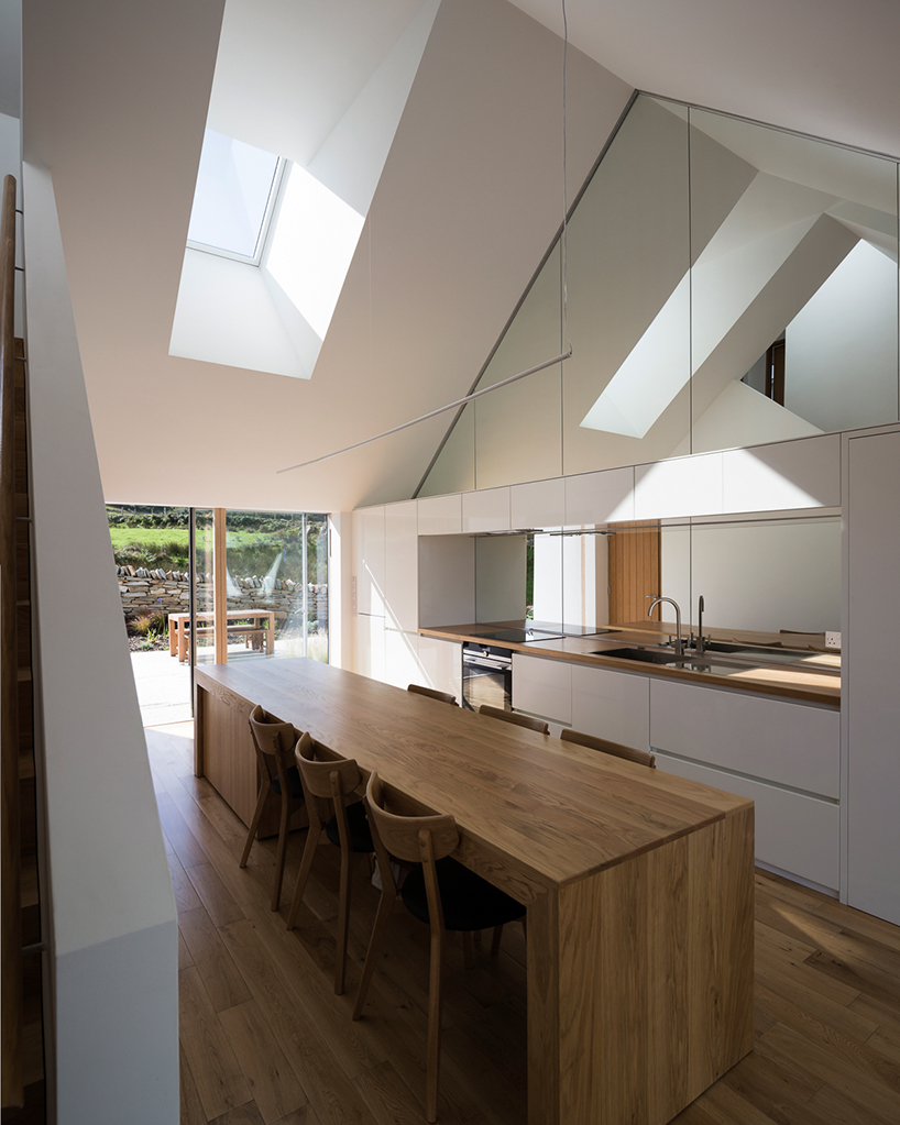 DUA completes cladach house with simple interiors and deep pitched roof in ireland