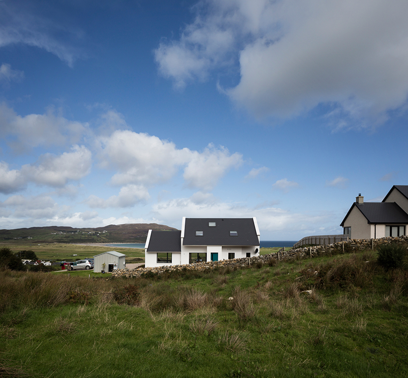 DUA completes cladach house with simple interiors and deep pitched roof in ireland
