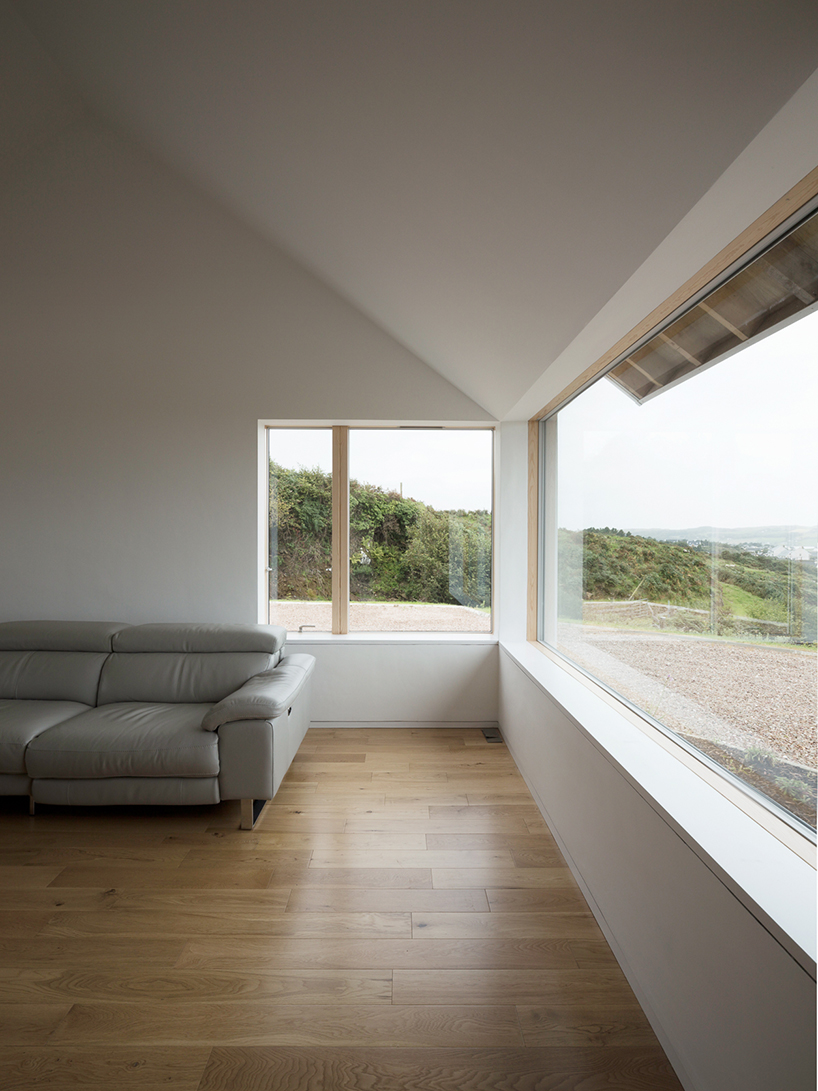 DUA completes cladach house with simple interiors and deep pitched roof in ireland