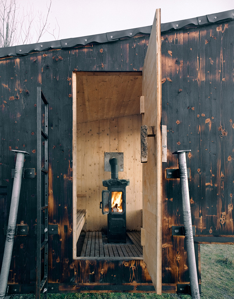 mobile sauna by BIVAK perches on recycled wooden stilts for an exclusive retreat