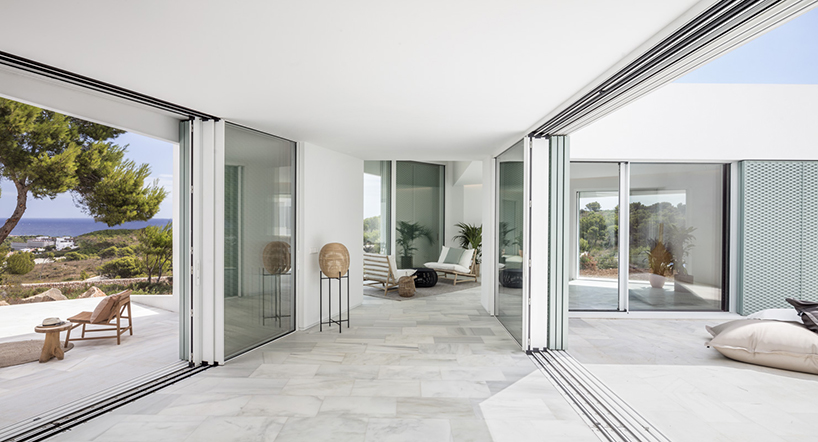 'patio house' by nomo studio offers unobstructed sea views in menorca, spain