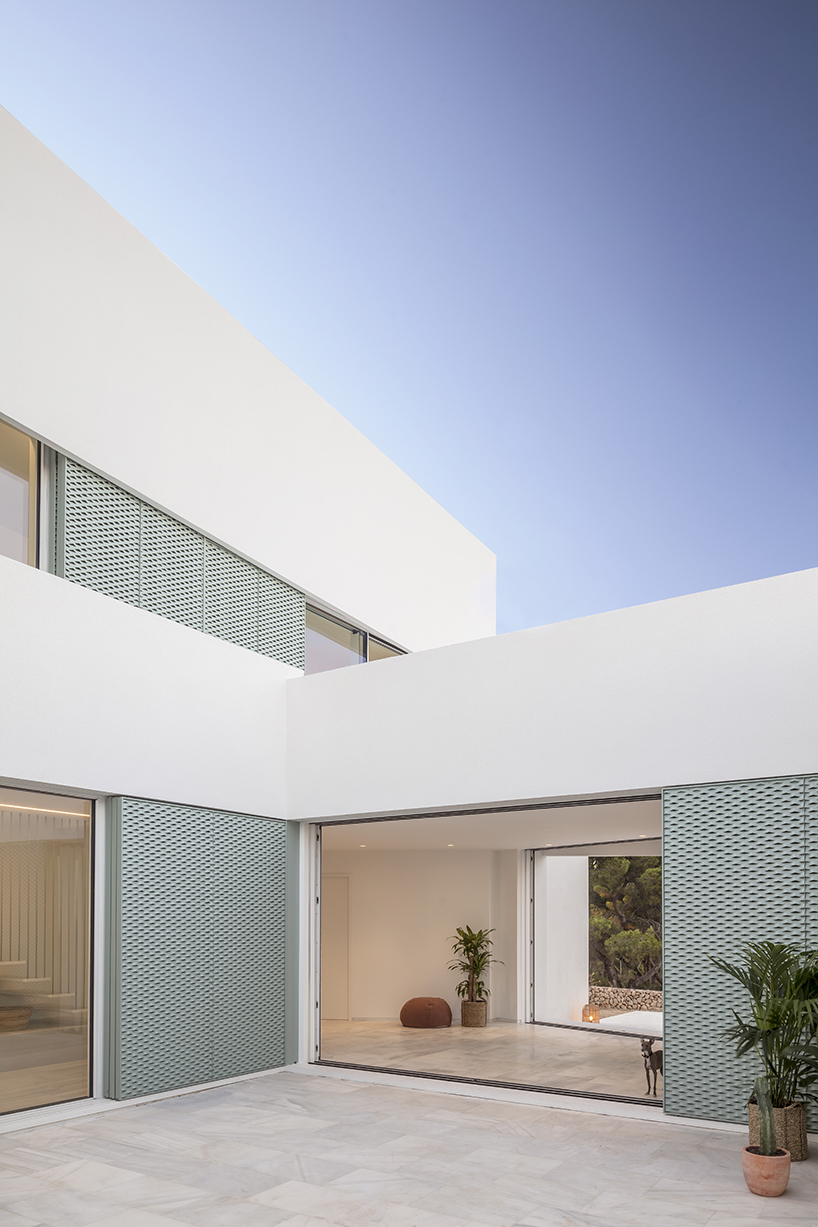 'patio house' by nomo studio offers unobstructed sea views in menorca, spain