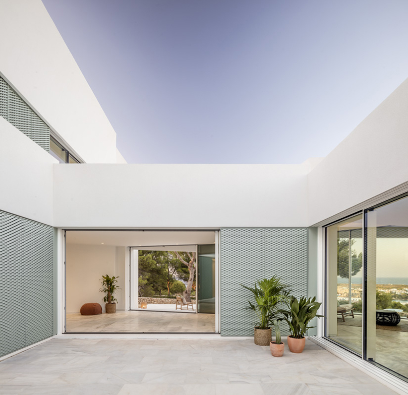 'patio house' by nomo studio offers unobstructed sea views in menorca, spain
