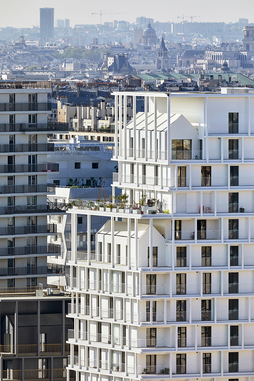 a white concrete exoskeleton frames AAVP's residential complex in paris designboom