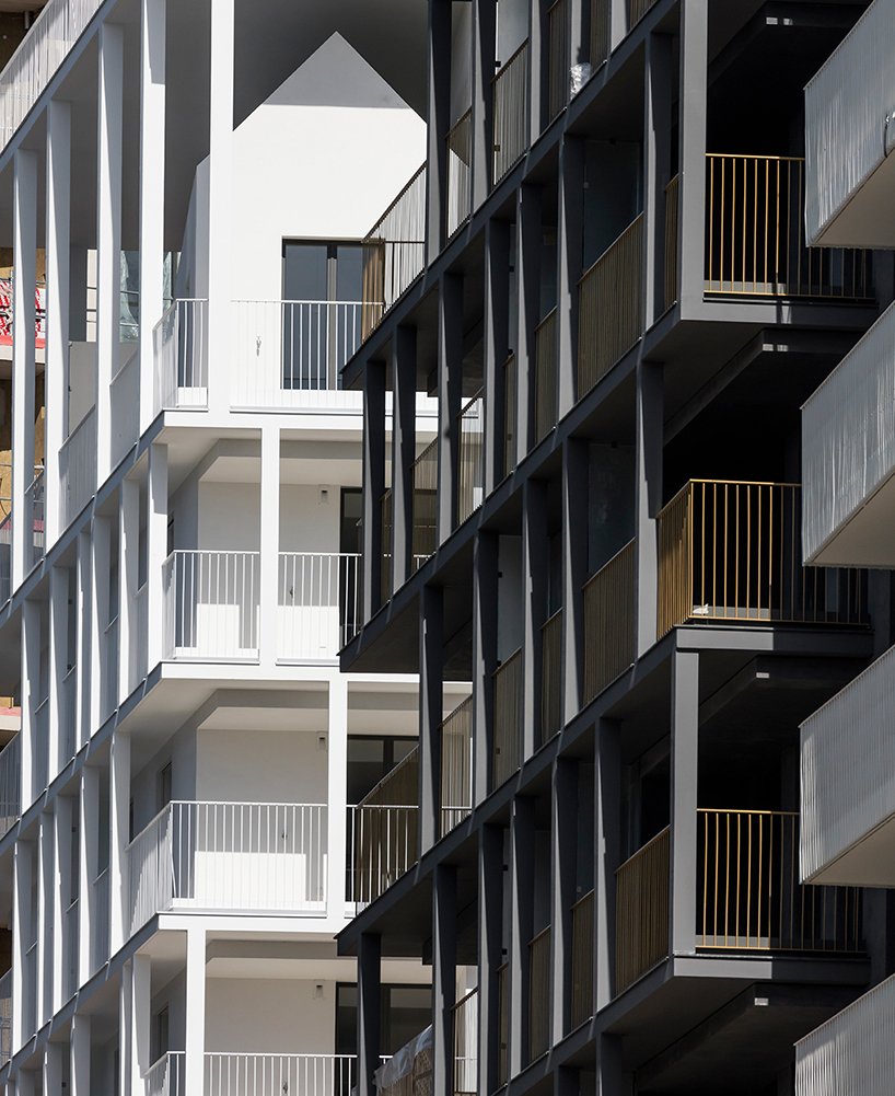 a white concrete exoskeleton frames AAVP's residential complex in paris designboom