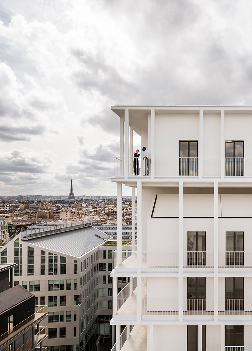 a white concrete exoskeleton frames AAVP's residential complex in paris designboom