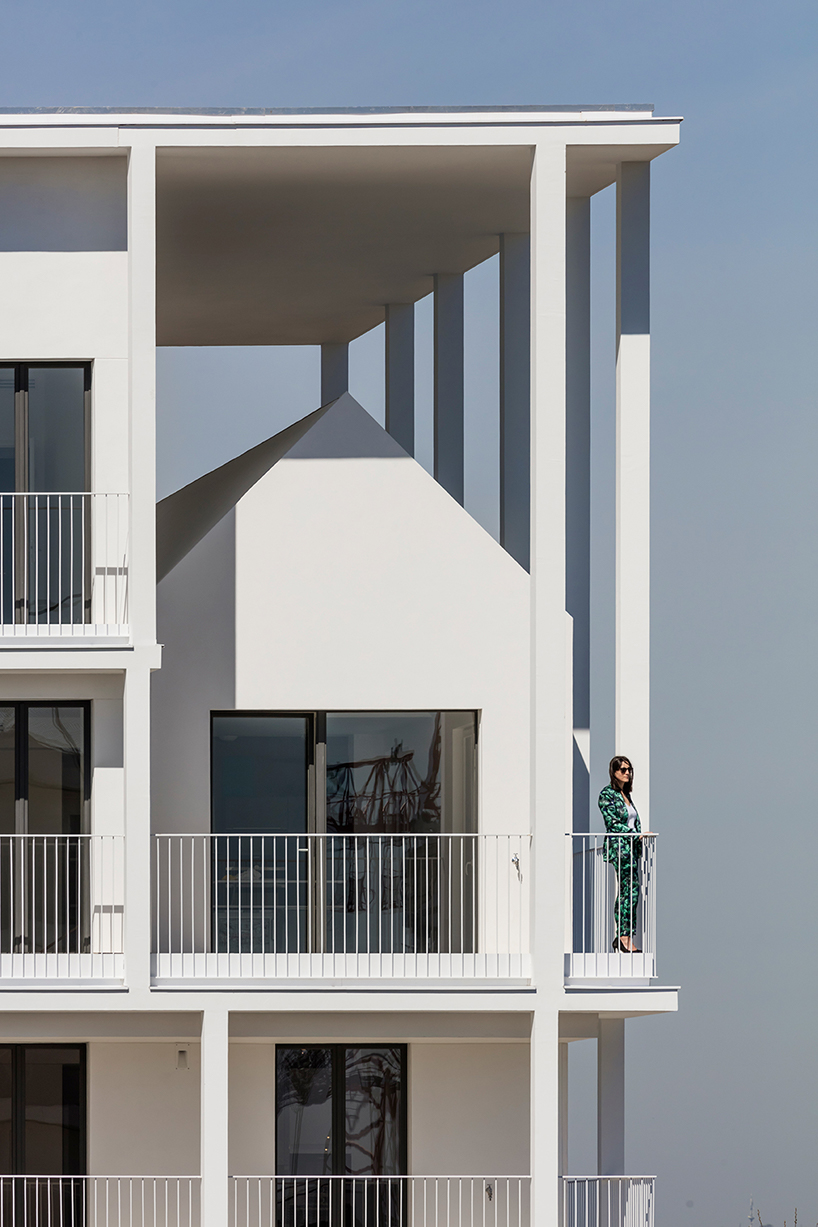 a white concrete exoskeleton frames AAVP's residential complex in paris designboom