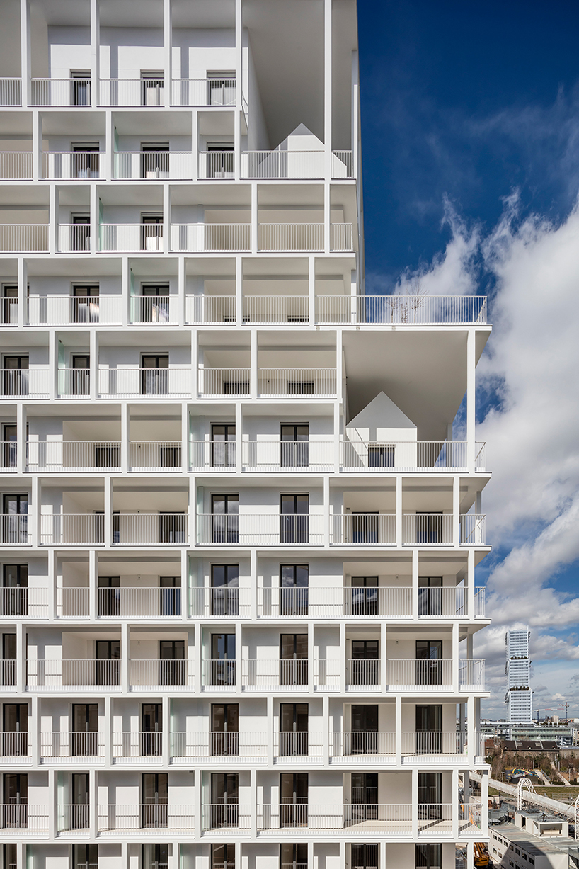 a white concrete exoskeleton frames AAVP's residential complex in paris designboom