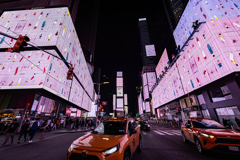 leaping olympic gymnasts form shifting colorfield in yuge zhou's NYC times square takeover