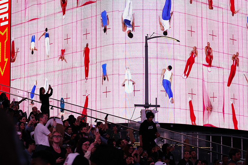leaping olympic gymnasts form shifting colorfield in yuge zhou's NYC times square takeover